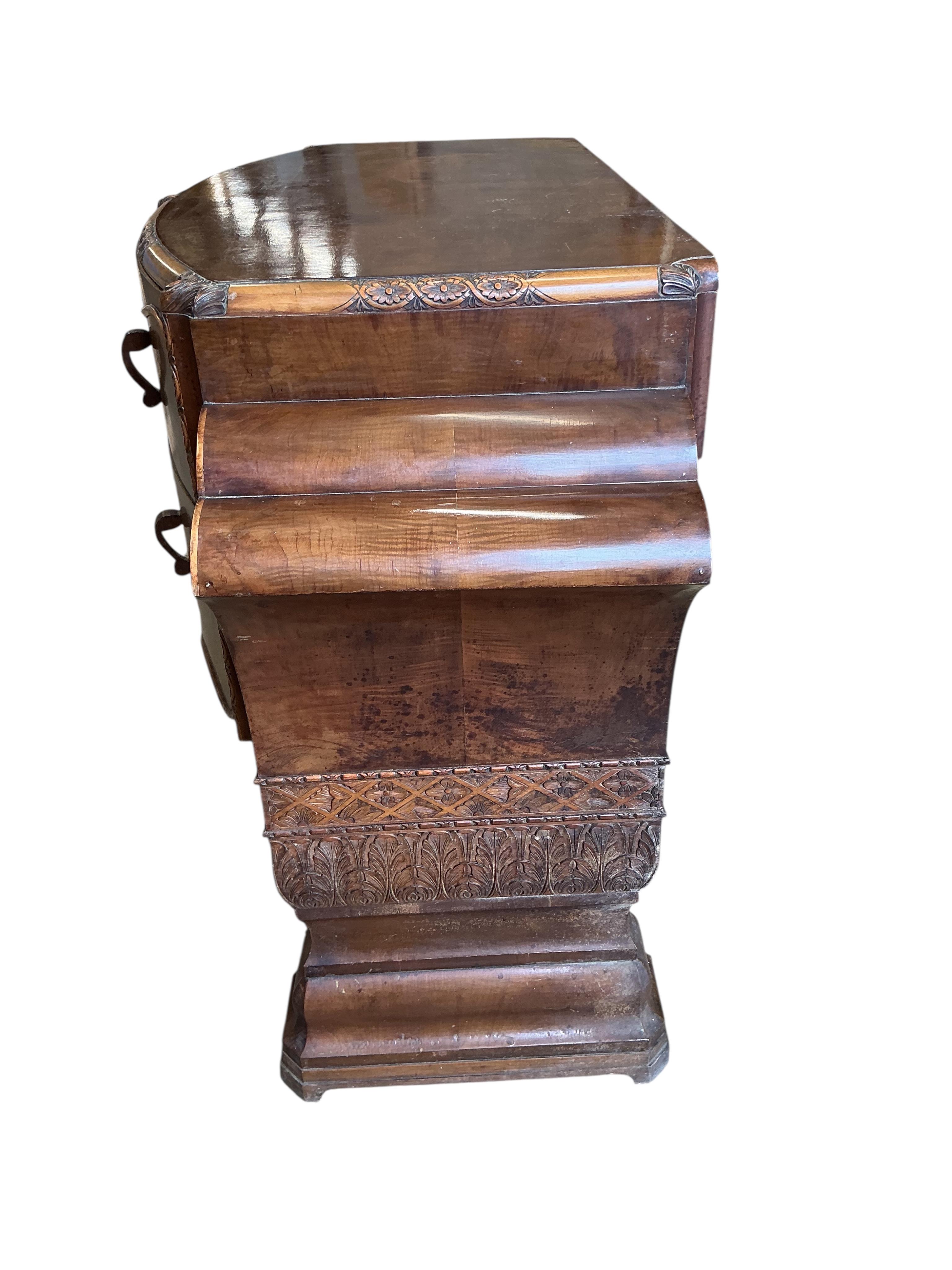 An Art deco walnut dining suite, comprising: dining table, width 190cm, depth 110cm, height 80cm together with eight chairs (two being carvers) and a bow front sideboard